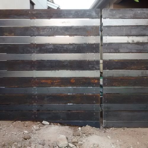 Beautiful horizontal metal fence made out of 4" an