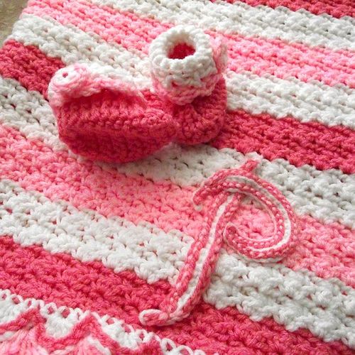 Crocheted baby blanket with matching booties.