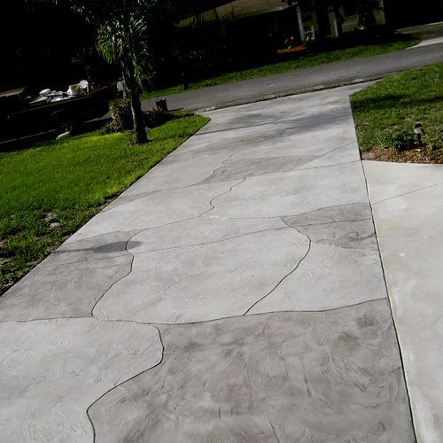 Severely cracked driveway resurfaced and cracks in
