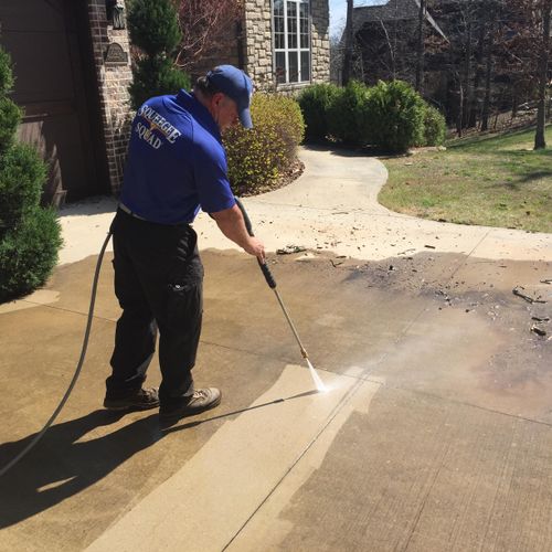 Pressure Washing a driveway.  What a difference!