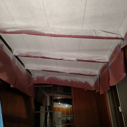 Spraying fiberglass ceilings.