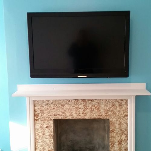 T.V. mounted above fireplace.