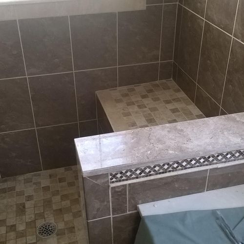 Multi level shower tile with border and shower pan