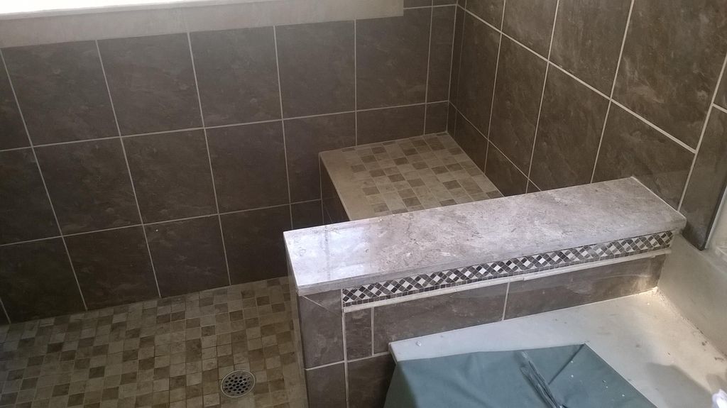 Multi level shower tile with border and shower pan