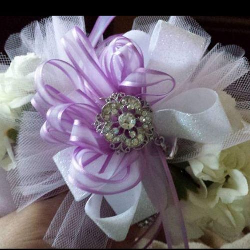 white carnations with lavender color ribbon and wh
