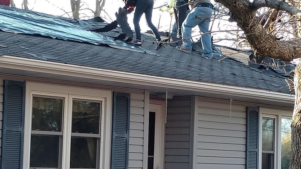 Before shot of a roof replacement due to wind dama