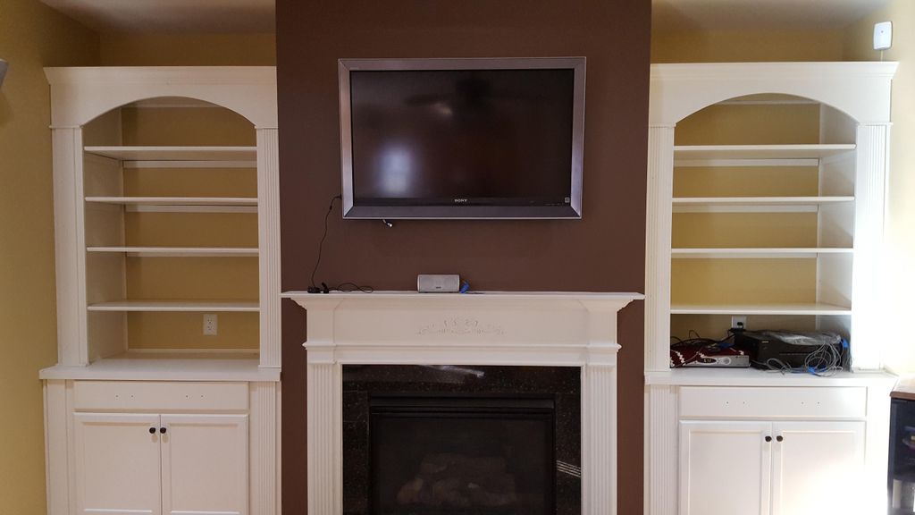 Closed up niche over fireplace, rerouted electrica
