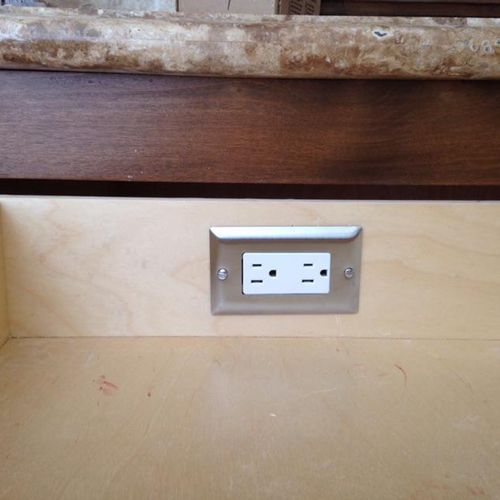 Receptacle added within the drawer for a hairdryer