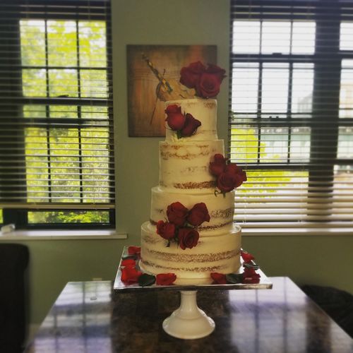 Naked 4 tier amaretto wedding cake. Adorned in fre