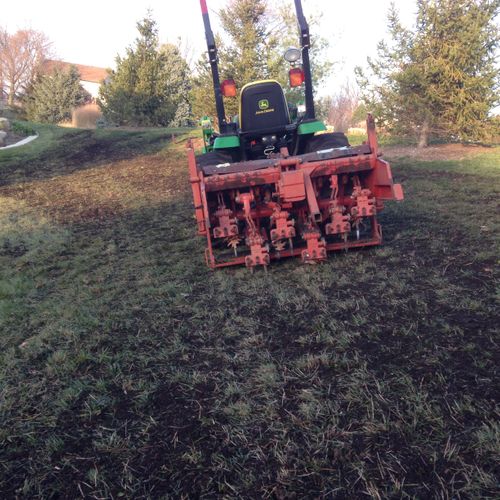 Top dressing a lawn with a organic compost mix wit
