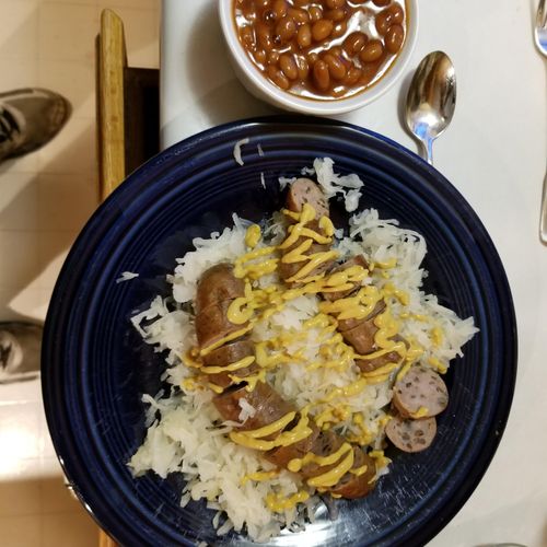 Wild Rice Brats seared in a pan and simmered in be