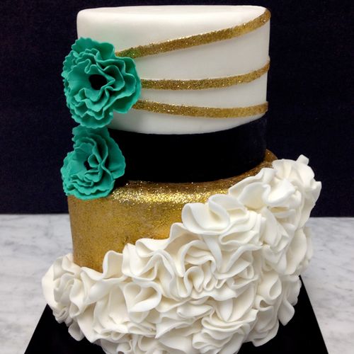 Opulent wedding cake matching the bride's gown