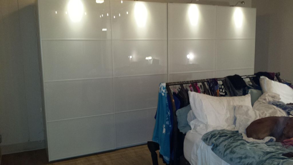 Assembly of IKEA wardrobe with sliding glass panel