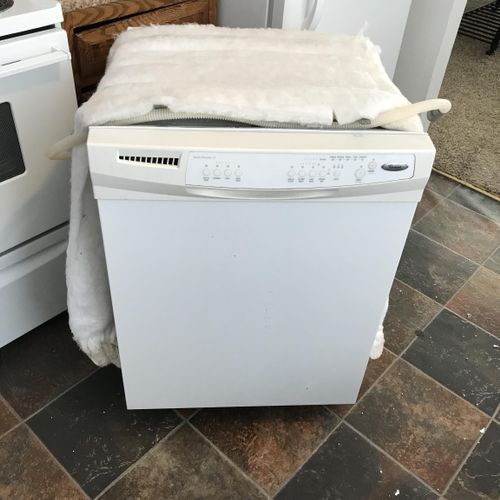 Old dishwasher removed and ready for disposal 