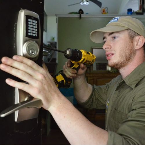 Residential Locksmith specialist Troy installing a