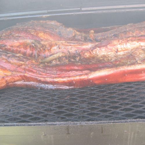 Us cooking a hog for a customer.
