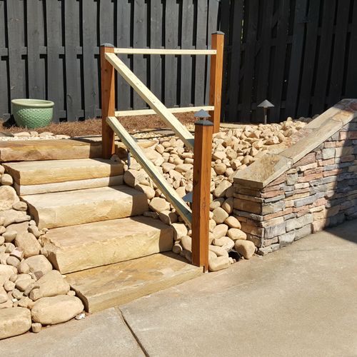 Crab Orchard steppers with river rock and handrail