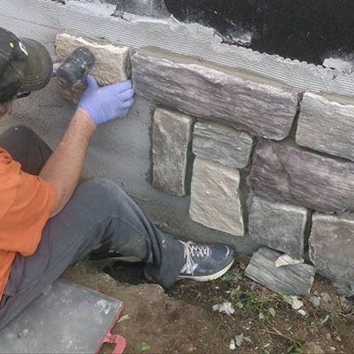 Adding stone to a foundation before siding was app
