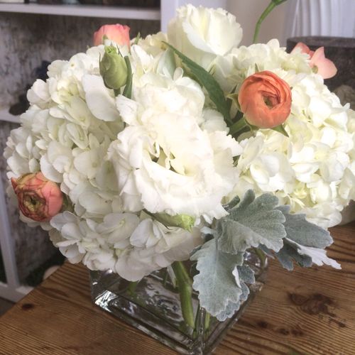 Table centerpiece with white hydrangeas,dusty mill