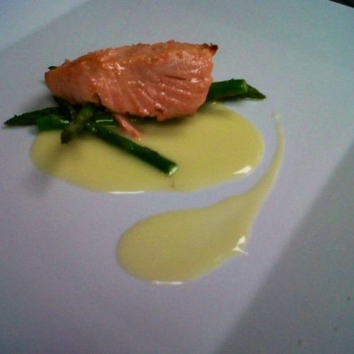 Pan seared salmon on a bed of grilled asparagus wi