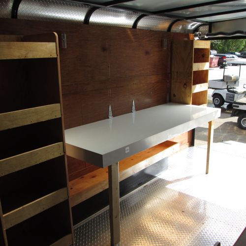 Built work shop with folding table in a trailer