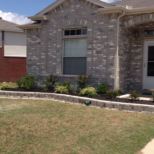 Landscape stones and shrubs/flowers added to front