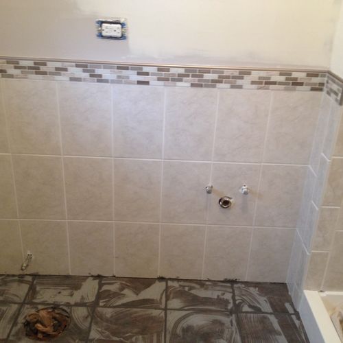 tiled full shower, floor and half walls