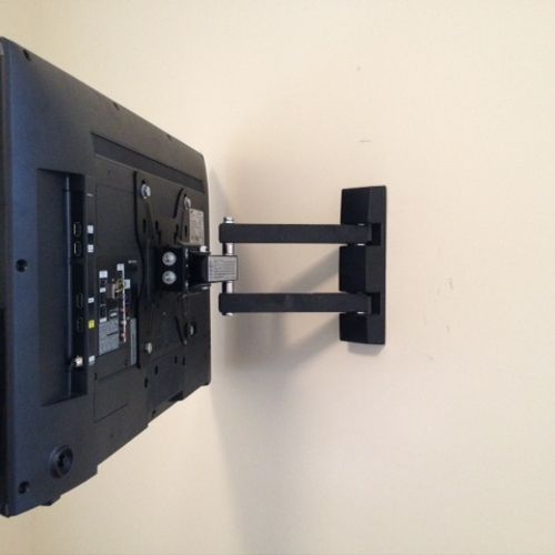 Universal TV wall mount installed and wiring hidde