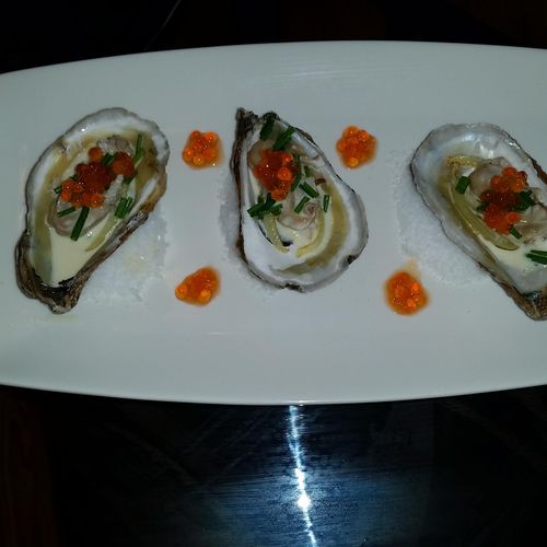 Poached Oysters in a white wine butter sauce, garn