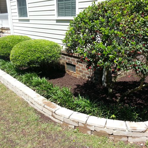 We built this retaining wall, trimmed the shrubs, 