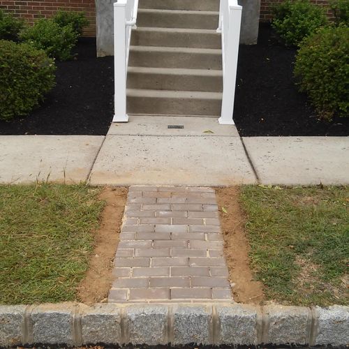 Installed landscape pavers at front entry of custo