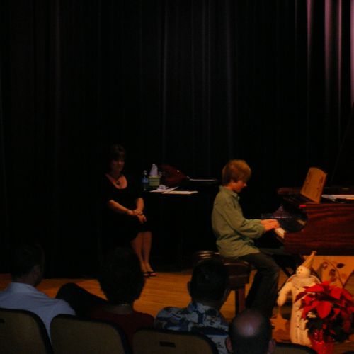 Students perform on a Steinway baby grand piano.