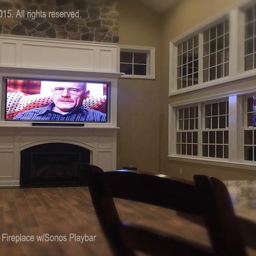 Custom recessed 80" TV fit above Kitchen/Family ro