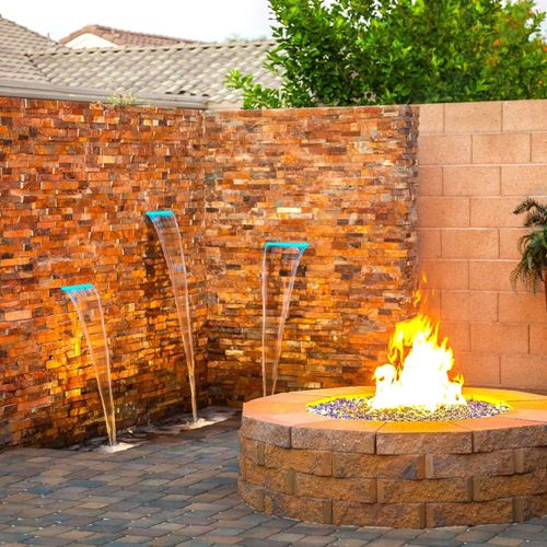 Water feature, fire pit, and paver patio installat