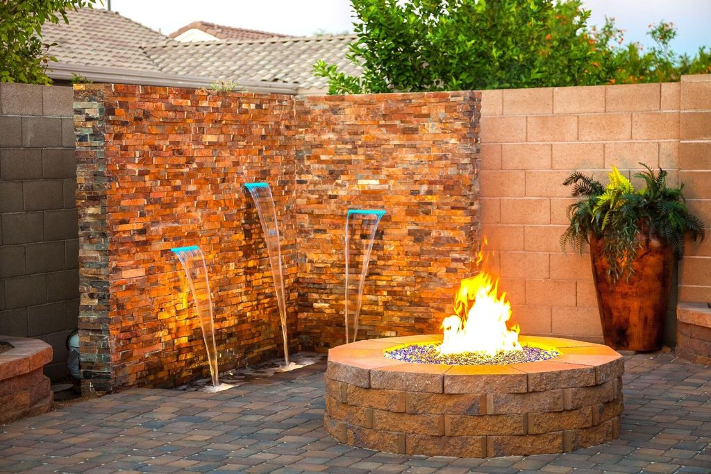 Water feature, fire pit, and paver patio installat