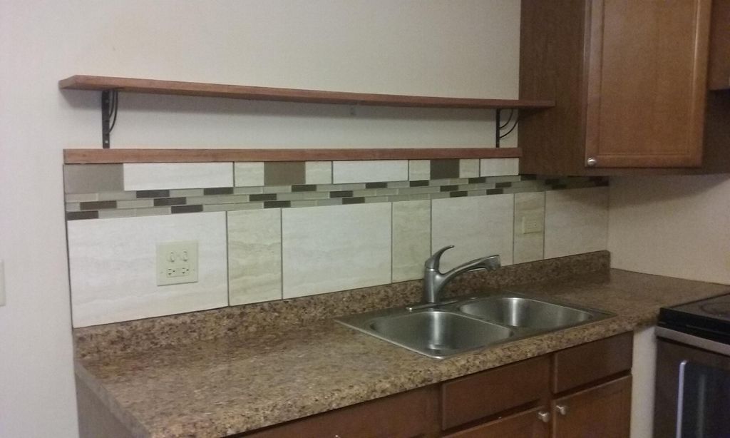 Custom designed backsplash and shelf installation.