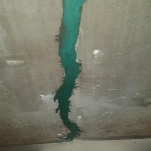 A foundation crack sealed with surface epoxy ready