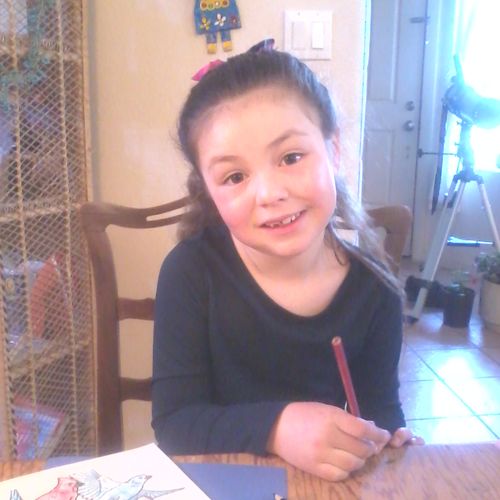 Thea, My first grade student in reading, writing a