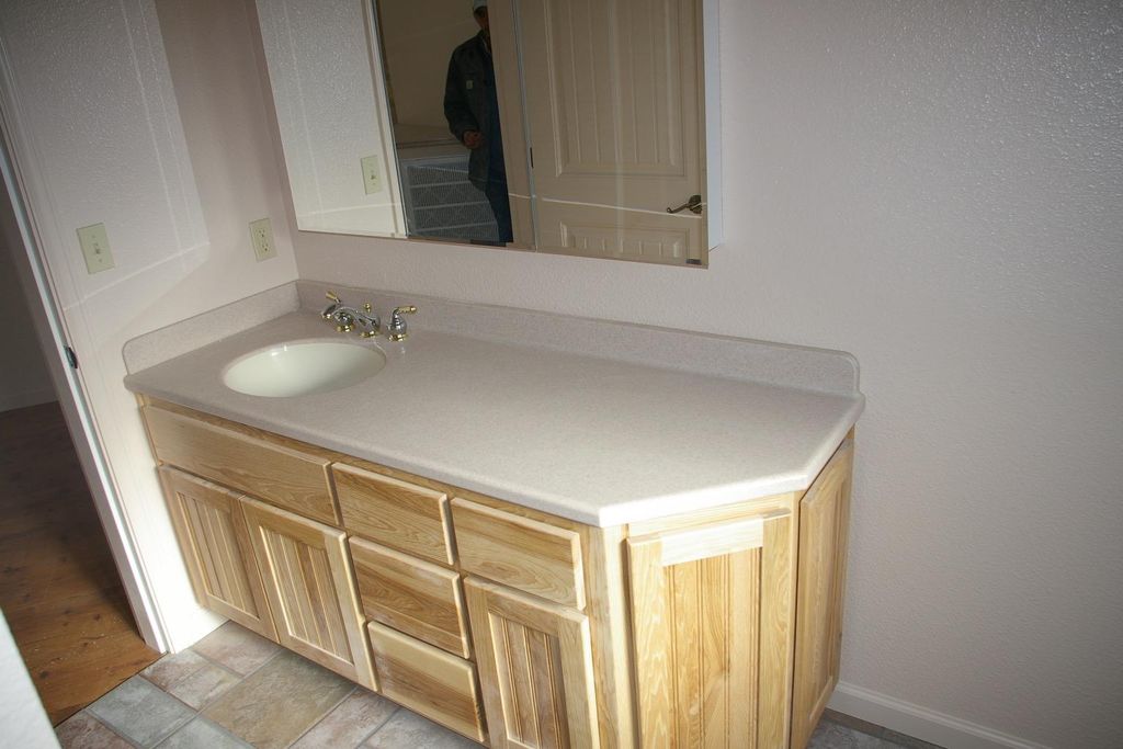 Custom Hickory Cabinet with Corian Top.