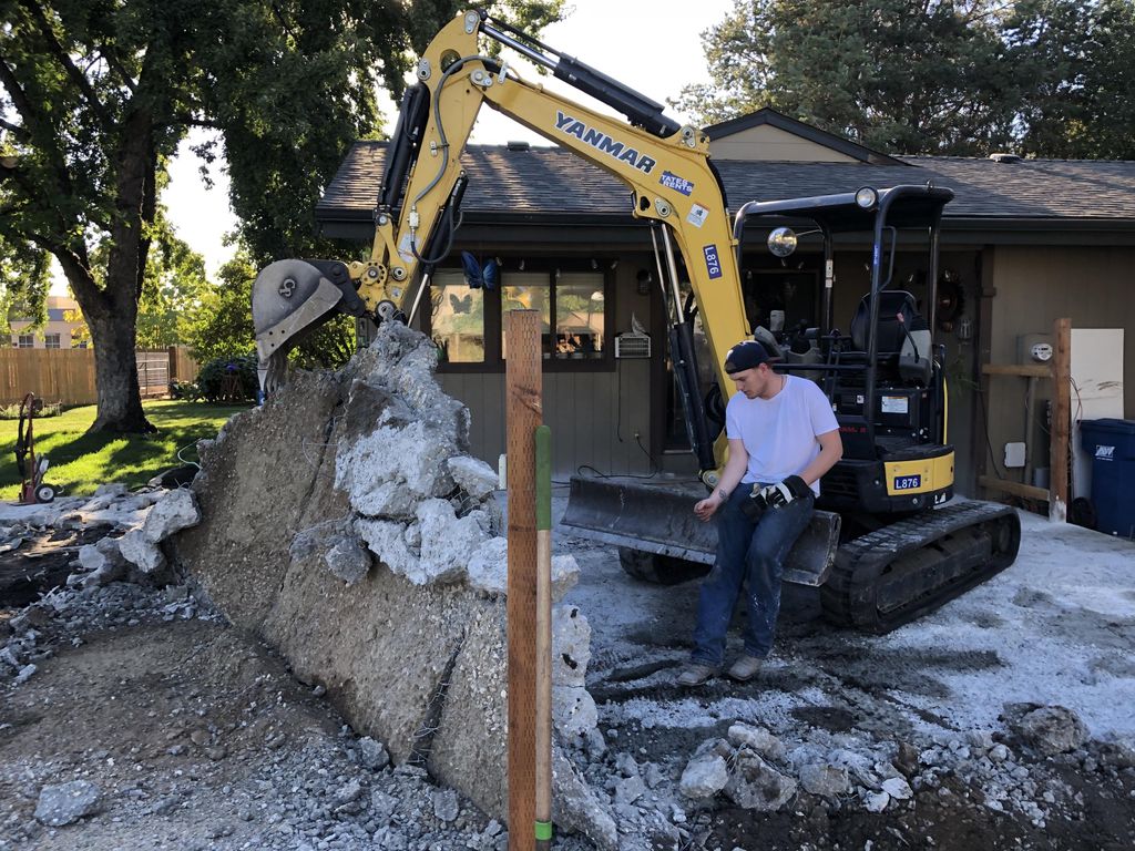 Demolition of a bad patio with chain link fencing 