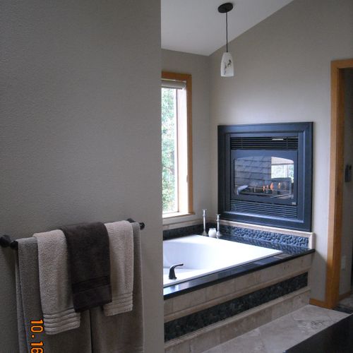 Northwest spa bathroom with the warmth of a firepl