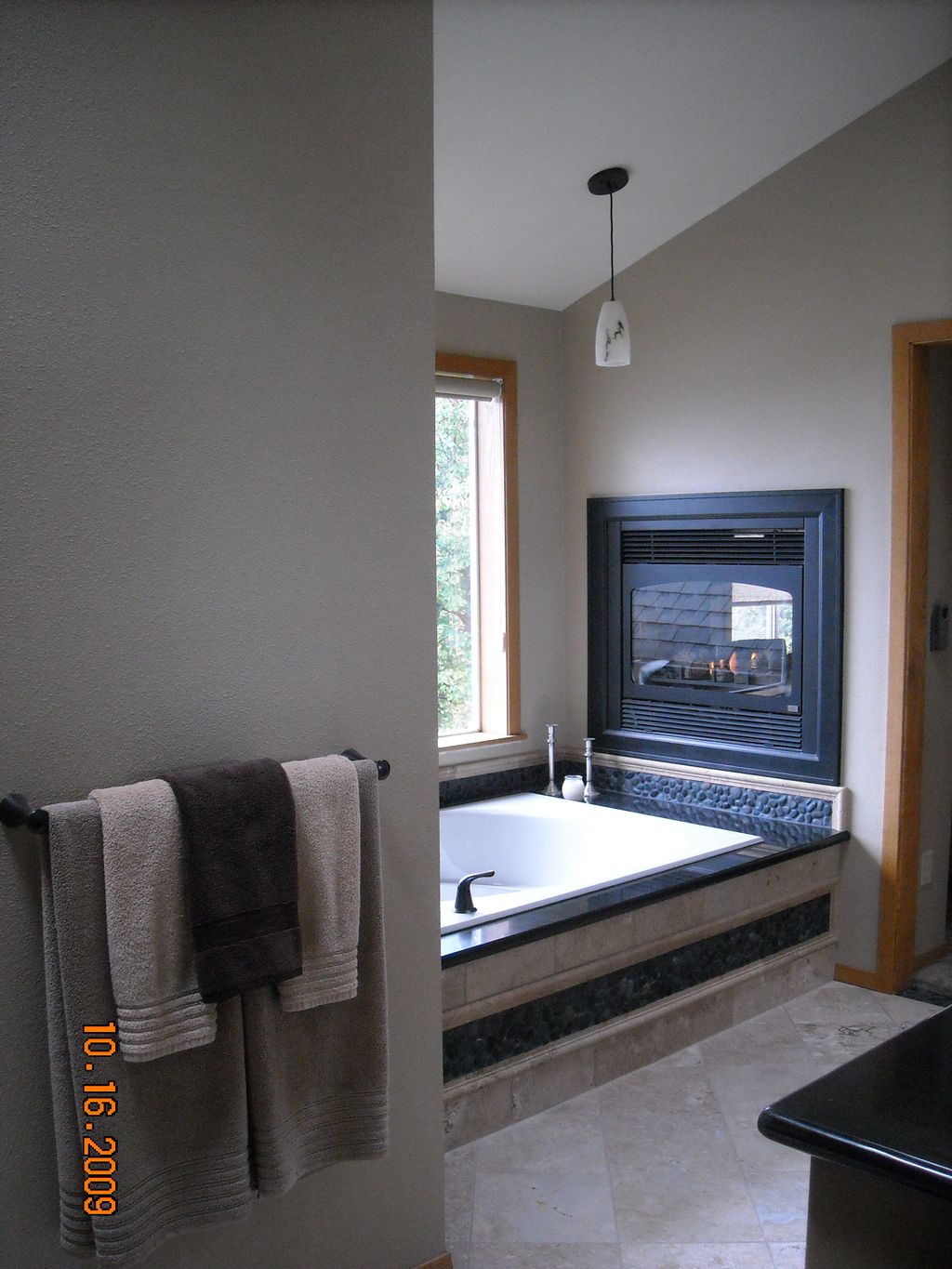 Northwest spa bathroom with the warmth of a firepl