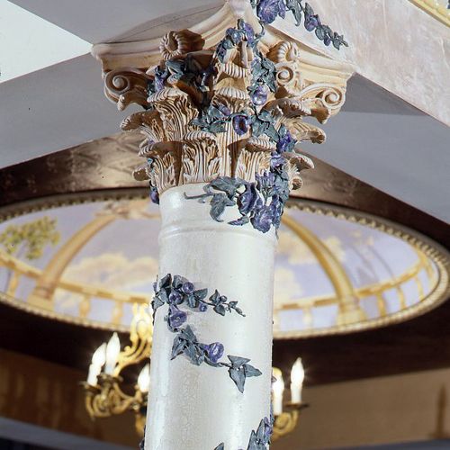 Column with painted ornamentation. In background a