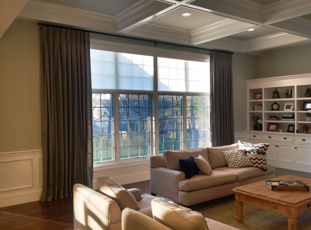 roller shades filter sunlight, framed with drapery