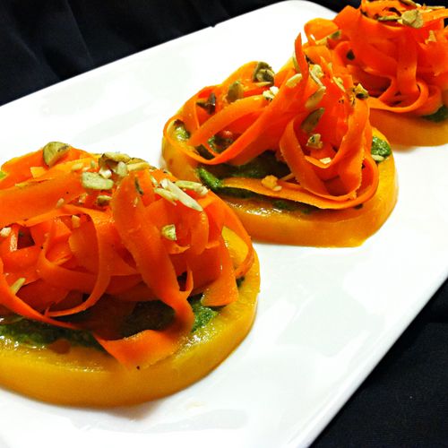 Heirloom tomato rounds topped with cilantro pumpki