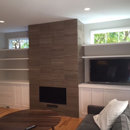 Built-in wall units around a fireplace. There are 