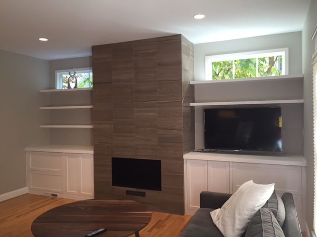 Built-in wall units around a fireplace. There are 