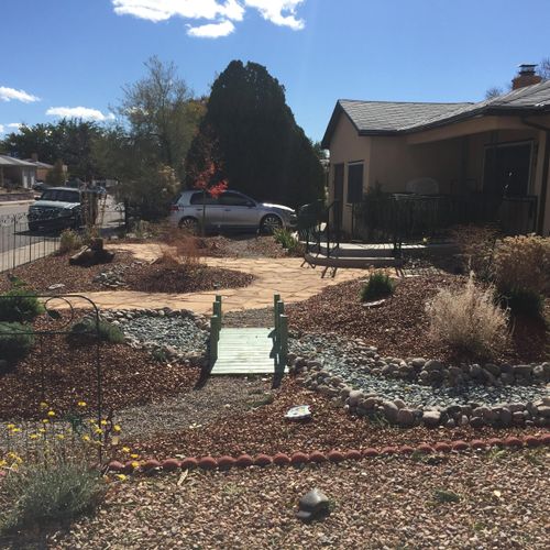 Xeriscaped home with a flagstone pathway as the ce