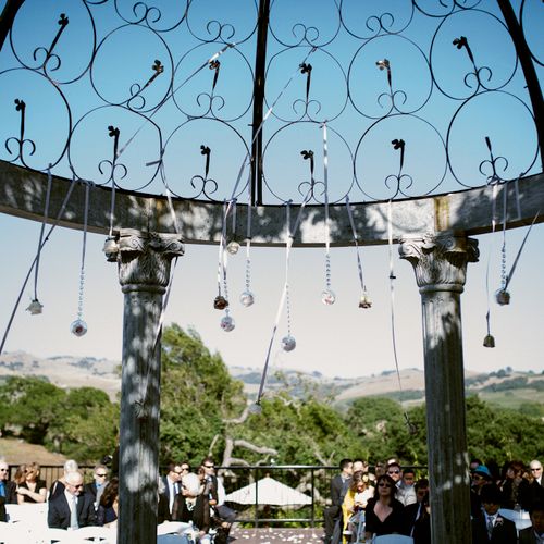 Hanging glass orbs and flowers in the vineyard for