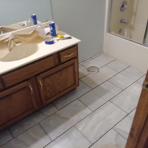 During. Floor repaired, new tile and vanity instal